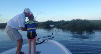 "Paw Pete" coaches Charli with a redfish on